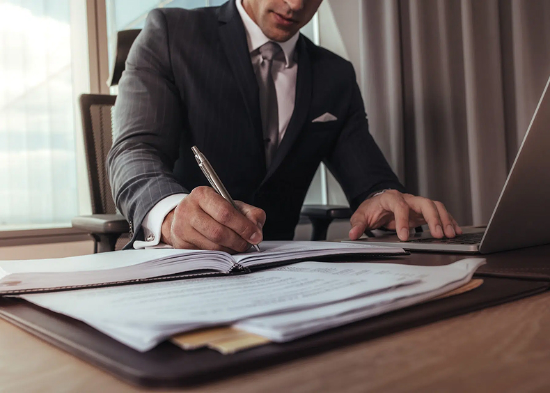 Lawyer writing notes at a desk | slip and fall attorney | The Law Offices of Edward Smith LLC