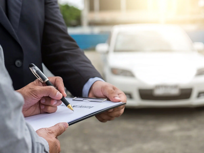 Hand signing a form on a clipboard | slip and fall lawyer | The Law Offices of Edward Smith LLC
