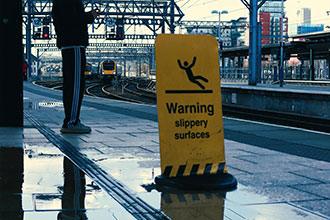 Wet floor warning sign on a train | slip and fall attorney | The Law Offices of Edward Smith LLC