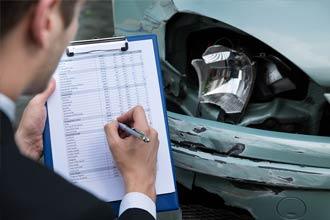 Man noting damage on a clipboard | car accident lawyer | The Law Offices of Edward Smith LLC