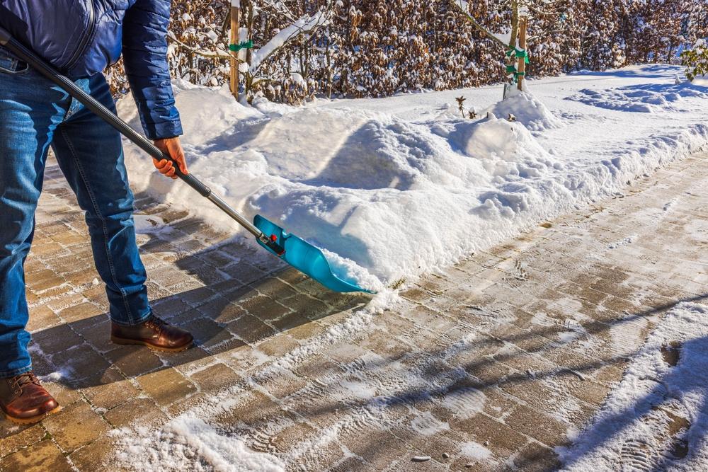 Person shoveling snow off | premises liability attorney | The Law Offices of Edward Smith LLC