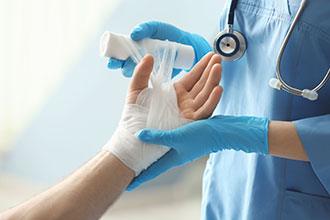 Bandaging a patient's hand | personal injury lawyer | The Law Offices of Edward Smith LLC