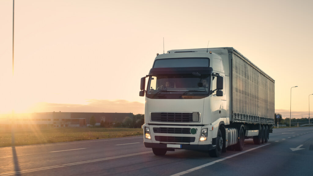 White semi truck driving down a road | truck accident attorney | The Law Offices of Edward Smith LLC