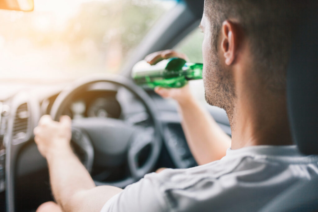 Man drinking from a bottle | drunk driving accident lawyer | The Law Offices of Edward Smith LLC